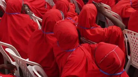 AFP Couples sit at the venue of a wedding reception at the Kano state governor's office after taking part in a mass wedding at the central mosque in Kano city, Kano State Nigeria on October 14, 2023.