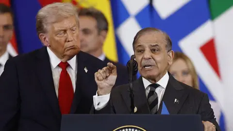 Getty Images US President Donald Trump (C) listens to Pakistan's Prime Minister Shehbaz Sharif (R) as he delivers a statement during a summit on Gaza in Sharm el-Sheikh on October 13, 2025