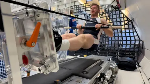 John Kennett Matthew Wells row floating on board a parabolic flight