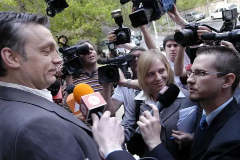 AFP via Getty Images Viktor Orban (L) answers questions after casting his vote in Budapest, 23 April 2006