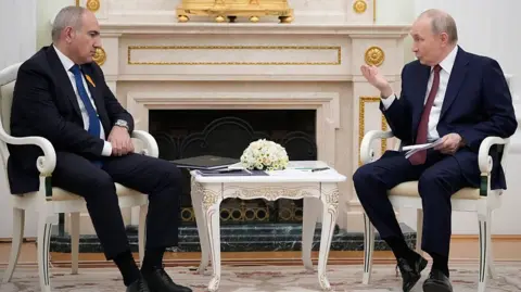 Pavel Bednyakov/POOL/AFP Russian President Vladimir Putin (R) speaks with Armenian Prime Minister Nikol Pashinyan during their meeting at the Kremlin in Moscow.
