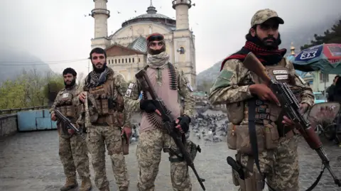 EPA Four members of the Taliban security forces holding guns in Kabul on 19 March 2026