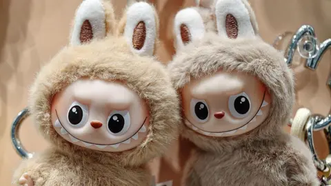 Getty Images A pair of mini-versions of the popular toy Labubu in an outlet of Pop Mart in China