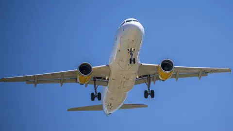 Getty Images Picture of the underside of an unmarked plane coming in to land