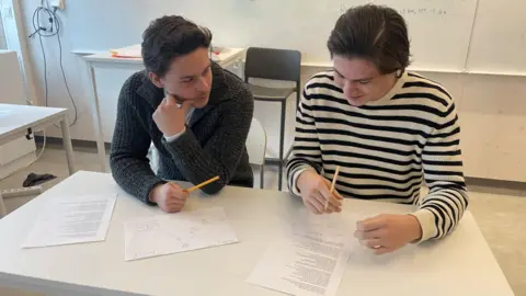Maddy Savage Sixteen-year-old pupils at a high school in Nacka, Sweden, using pencils and paper