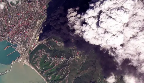 Reuters A satellite image of smoke rising after, according to Ukraine's military, an overnight strike on an oil refinery in Tuapse, Russia