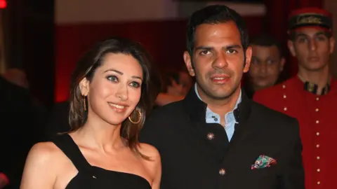 Getty Images Sanjay Kapur (R) and Karishma Kapur attend the inauguration of the new Cartier Boutique at Dubai Mall on March 26, 2009 in Dubai, United Arab Emirates. Today Cartier officially inaugurated its largest boutique in the Middle East in the prominent and lavish Dubai Mall