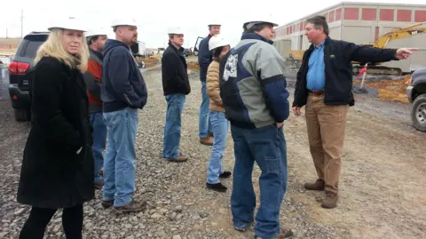 SilkoTek Corporation Paul Silvis, right, with staff at manufacturing business SilkoTek Corporation