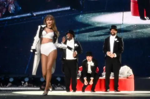 Getty Images Taylor Swift is joined on stage by Travis Kelce (R), during "Taylor Swift | The Eras Tour" at Wembley Stadium on June 23, 2024 in London, England. 