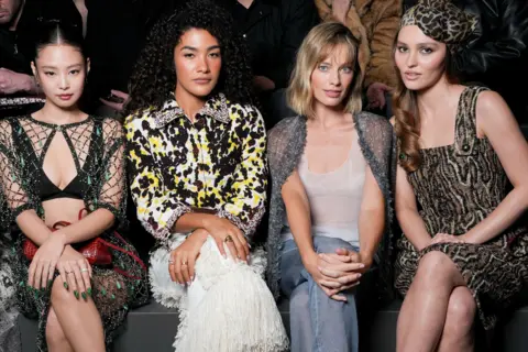 Swan Gallet/WWD via Getty Images Jennie Kim, Olivia Dean, Margot Robbie and Lily-Rose Depp at the Chanel fashion show as part of Paris Fashion Week Fall 2026 held at Grand Palais on March 09, 2026 in Paris, France. 