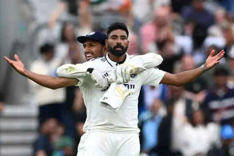 Getty Images Mohammed Siraj of India celebrates the match winning wicket of Gus Atkinson of England with teammate Dhruv Jurel on day five of the 5th Rothesay Test Match at The Kia Oval.