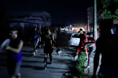 Reuters Dozens of protesters carrying pots and pans run through the streets of Havana at night in protest of recent energy shortages.