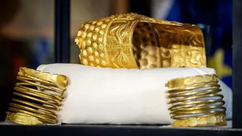 ANP/AFP A gold helmet and two gold bracelets