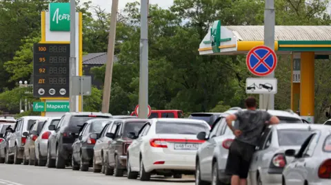 Reuters Cars queue for fuel at a gas station after the authorities restricted fuel sales amid a supply shortage following Ukrainian attacks on logistics routes