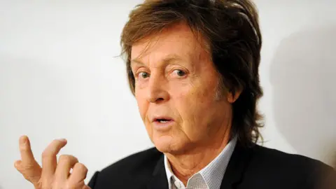 Dave J Hogan/Getty Images Headshot of musician Paul McCartney, wearing black blazer and open-necked shirt, taken in 2014 