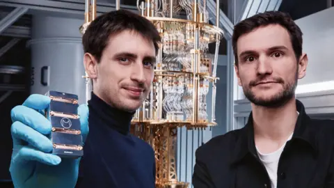 Alice & Bob Théau Peronnin holds one of his company's computer chips and stands next to co-founder Raphaël Lescanne.