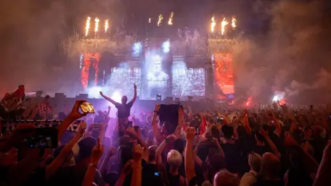 DAMIR SENCAR/AFP via Getty Images A huge crowd of fans facing the stage at Perkovic's concert. Fireworks and flames are seen coming from the stage.
