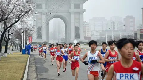 AFP via Getty Images Runners at the 31st Pyongyang International Marathon in Pyongyang on April 6, 2025
