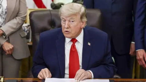 EPA US President Donald Trump speaks to reporters during a signing ceremony in the Oval Office.