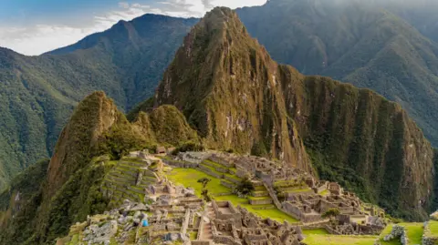 Getty Images Wide view of Machu Picchu with the ruins in the foreground and the mountains in the background