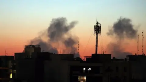EPA Smoke rising from the skyline at sunrise in central Tehran