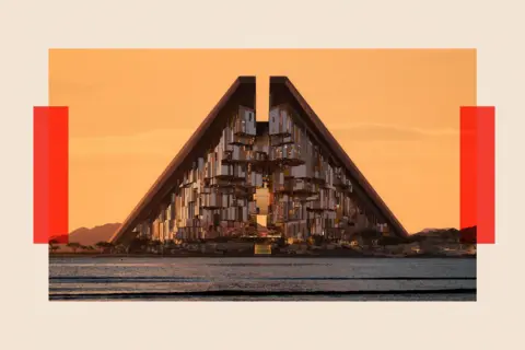 NEOM A futuristic building that rises into a point in the middle. It is called Gidori and is an 'ultra modern community' that is part of the Neom development