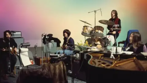 Disney+ The Beatles in the studio during the recording of Let It Be