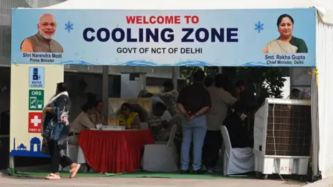 Hindustan Times via Getty Images Visitors and commuters seek respite from summer heat inside a special cooling zone near the Jama Masjid Metro Station on May 11, 2026 in New Delhi, India. 