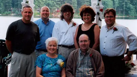 Submitted photo Standing left to right: are the Boucher siblings - Daniel Boucher, William Boucher, Robert Boucher Jr, Therese Boucher, Joseph Bouche. The elder Robert Boucher and his wife sit in front. Many wear boutonnieres.