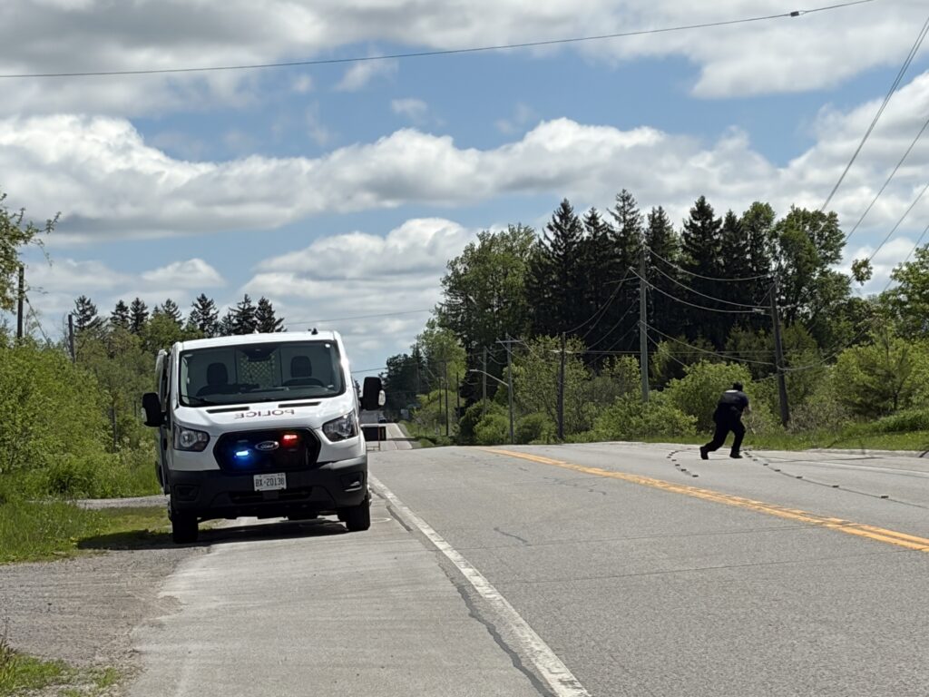 Police examine tire marks on the roadway after a vehicle crashed on Myrtle Street near Baldwin Street North in Whitby on May 28, 2026