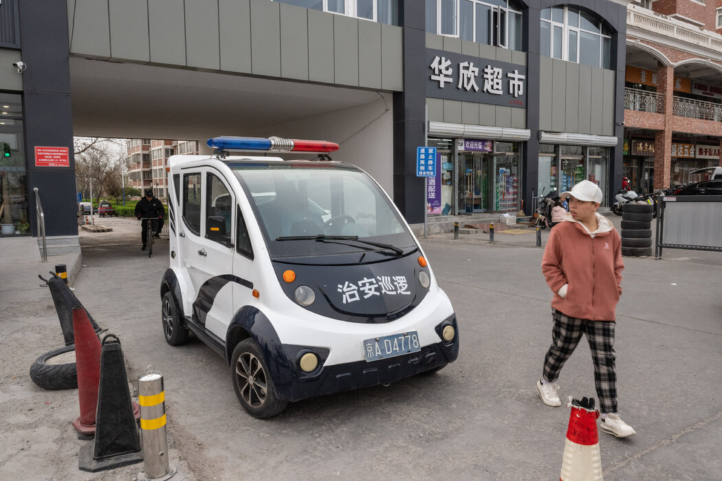 京郊張家灣一個公寓樓入口處停著一輛警車。警察的身影可能讓人感到不安,但一些居民也表示感到更安全了。