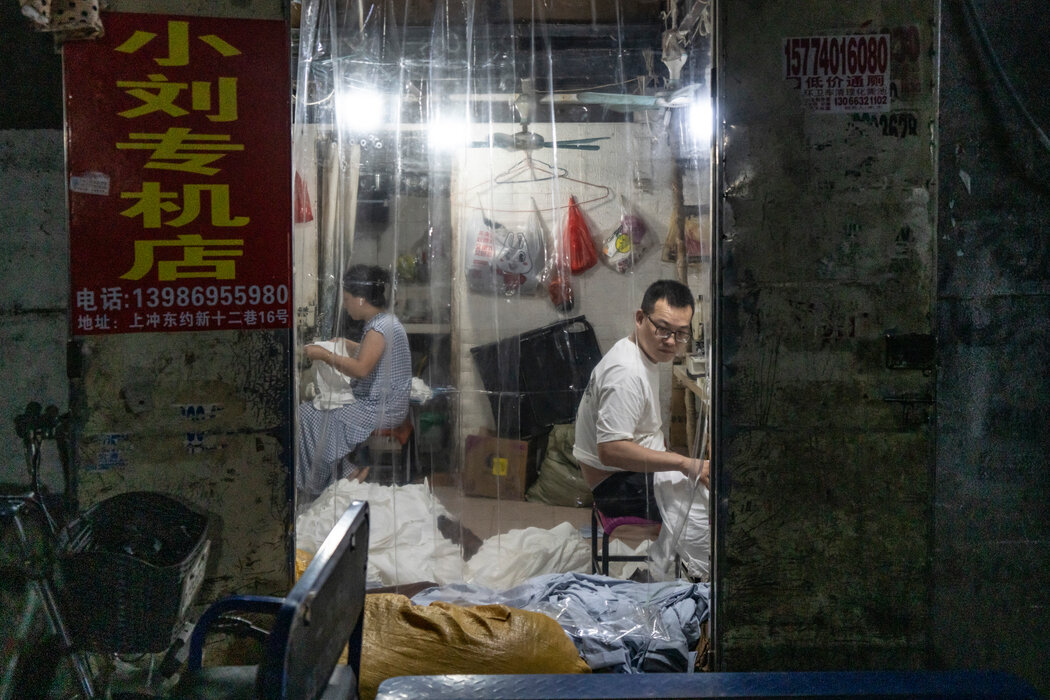 一些服裝廠安裝了空調,為了能透光同時不跑冷氣,他們在門口掛了塑料布。