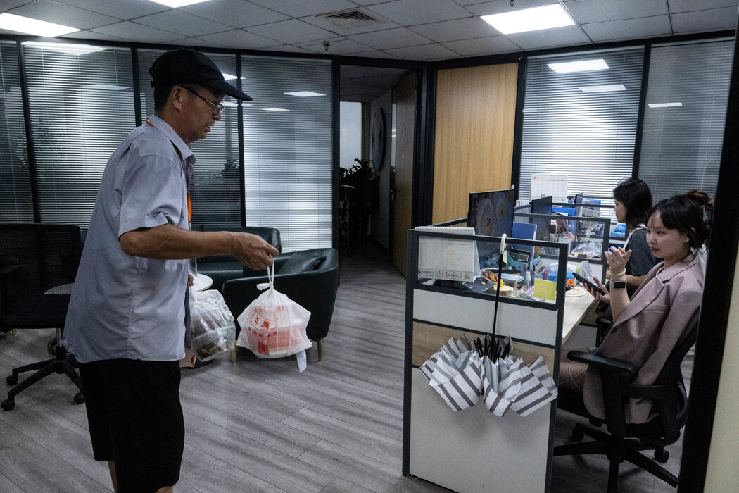 一名代送跑腿員正在賽格廣場的一間辦公室裡尋找訂餐的顧客。