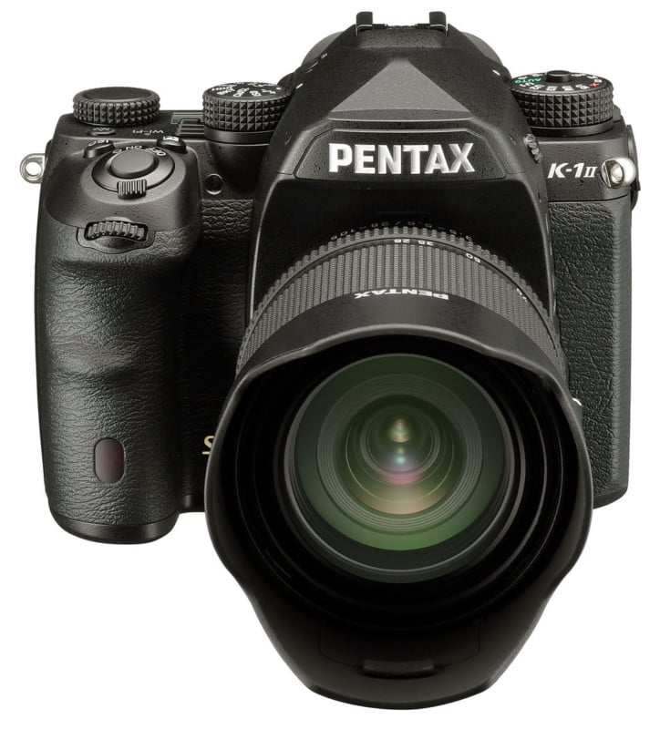 A black Pentax K-1 Mark II DSLR camera with a lens attached, viewed from the front against a white background.