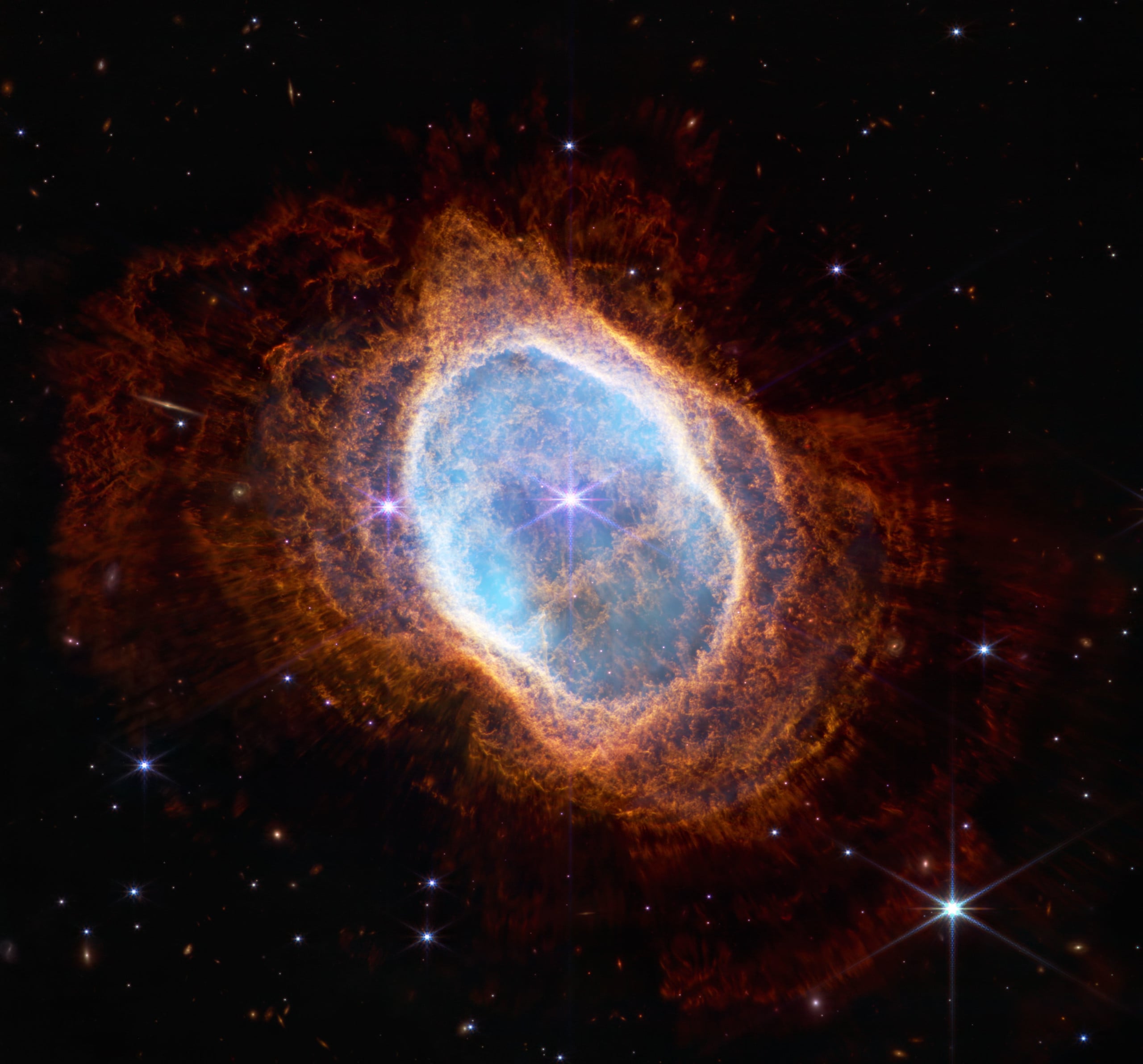 space photo with blue and orange nebula in the middle against a starfield
