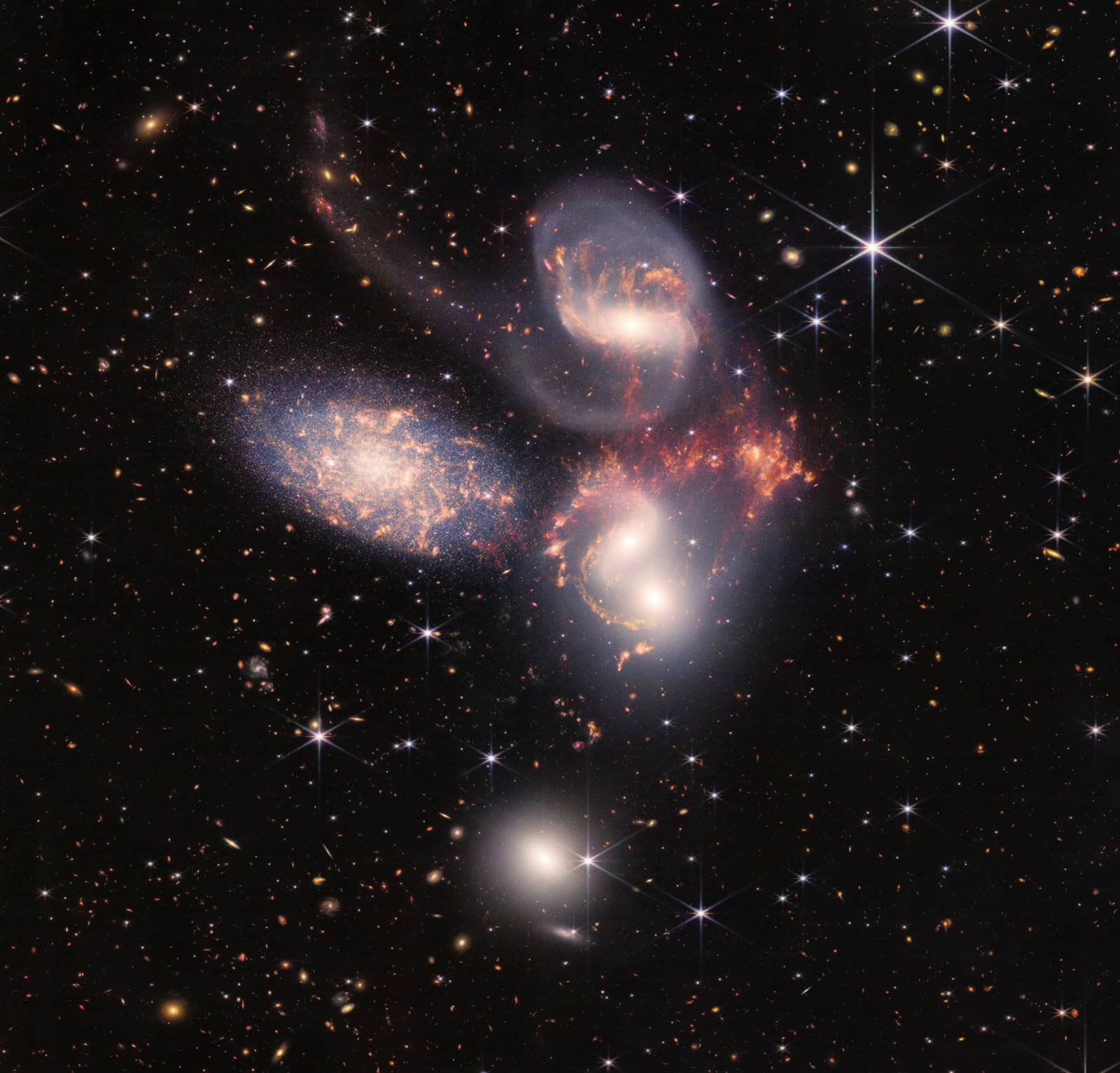 A space photo showing five large spiral galaxies against a field of smaller, more distant stars and galaxies