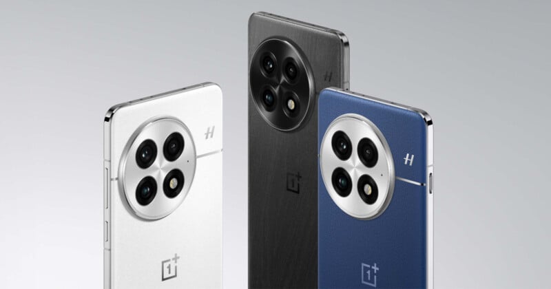 Three smartphones are displayed, showcasing their backs. The phones feature a circular triple-camera module with a textured finish. The colors from left to right are white, black, and blue. Each phone has a shiny metallic edge and a logo below the cameras.