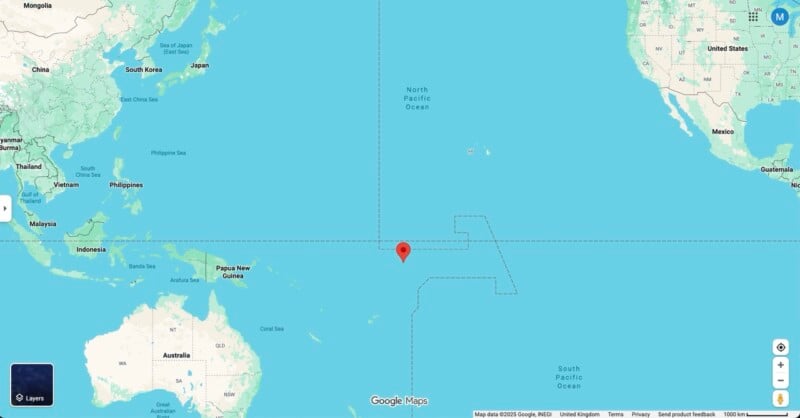 A Google Maps screenshot shows a red location pin in the central Pacific Ocean, surrounded by Australia, Asia, and North America, indicating a remote oceanic point far from any major landmass.