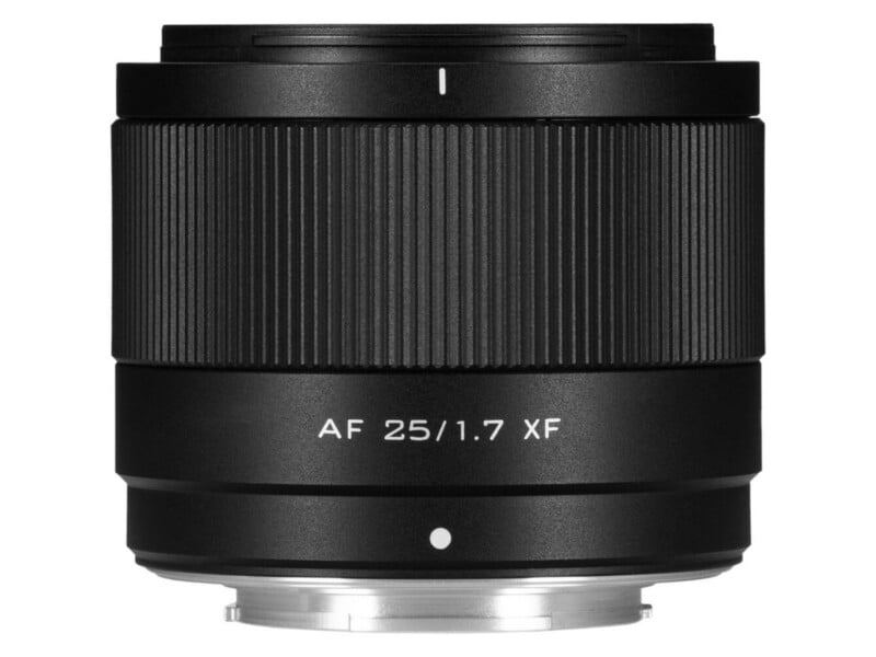 A black camera lens labeled "AF 25/1.7 XF" with textured focus ring, viewed from the side against a white background.