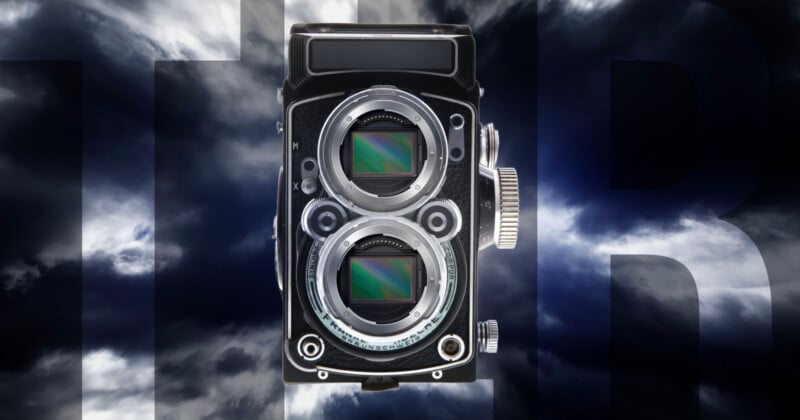 A vintage twin-lens camera with two visible digital sensors is set against a dramatic, cloudy sky background with large, partially visible letters 
