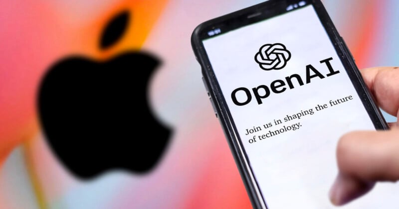 A hand holds a phone displaying the OpenAI logo and text, with a blurred Apple logo in the colorful background.
