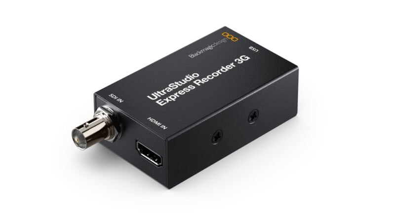 A compact black UltraStudio Express Recorder 3G device with SDI IN and HDMI IN ports, used for video capture, is shown angled on a white background.