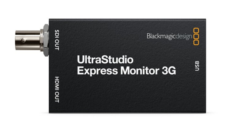 A Blackmagic Design UltraStudio Express Monitor 3G device with SDI OUT, HDMI OUT, and USB ports labeled on its black rectangular casing.