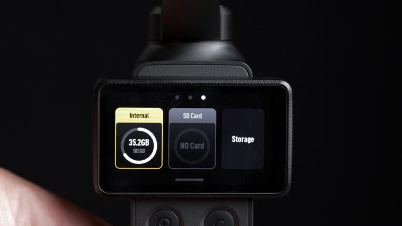 A close-up of a small digital screen displaying storage options, showing 35.2GB of 103GB used on internal storage and a "NO Card" status for the SD card slot.