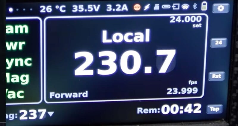 A digital display shows "Local 230.7 Forward," with settings including 26°C, 35.5V, 3.2A, 24.000 set, 23.999 fps, and a timer reading "Rem: 00:42." Various icons and data are visible around the edges.