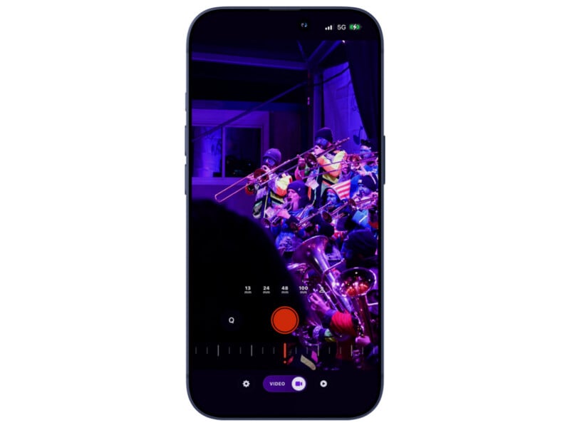 A smartphone screen shows a live video recording of a brass band performing under purple stage lights. Recording controls are visible at the bottom of the phone display.