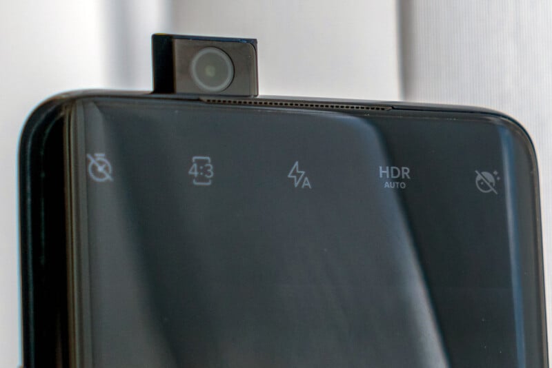 Close up photo of a smartphone with a camera sticking up from the top of the device