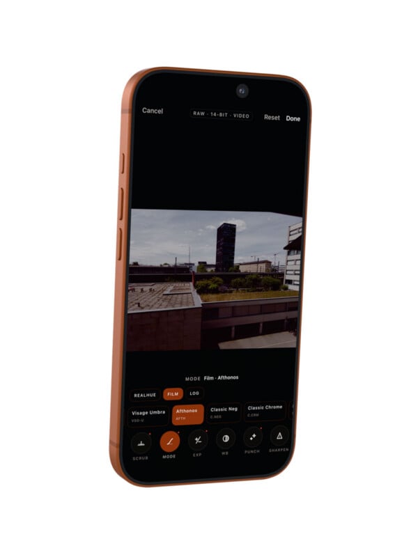 A smartphone displays a photo editing app with a cityscape image on screen. Editing options and filters are visible below the photo.
