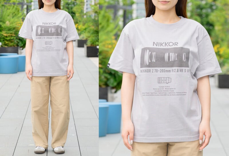 A woman stands outdoors wearing a gray NIKKOR T-shirt with lens graphics, light brown pants, and casual shoes. The background includes plants and urban elements. Close-up shows shirt details.