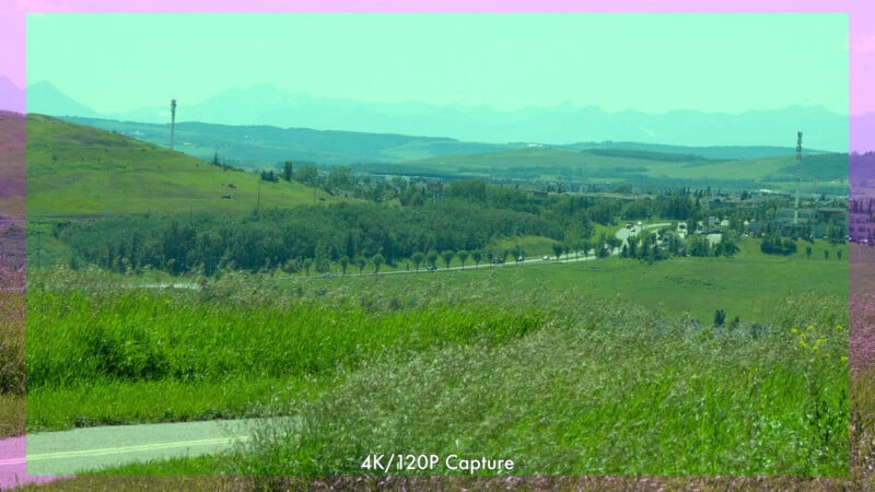View of a green landscape with hills, roads, and scattered trees under a wide sky. The image has a pink and green color filter. Text at the bottom reads "4K/120P Capture.